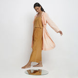 Left View of a Model wearing Powder Pink Vegetable Dyed Handspun Cotton Notched Collar Front Open Overlay