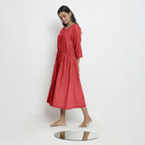 Left View of a Model wearing Vegetable-Dyed Red 100% Cotton Button-Down Dress