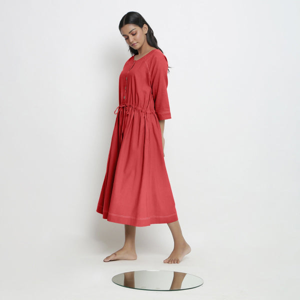 Left View of a Model wearing Vegetable-Dyed Red 100% Cotton Button-Down Dress