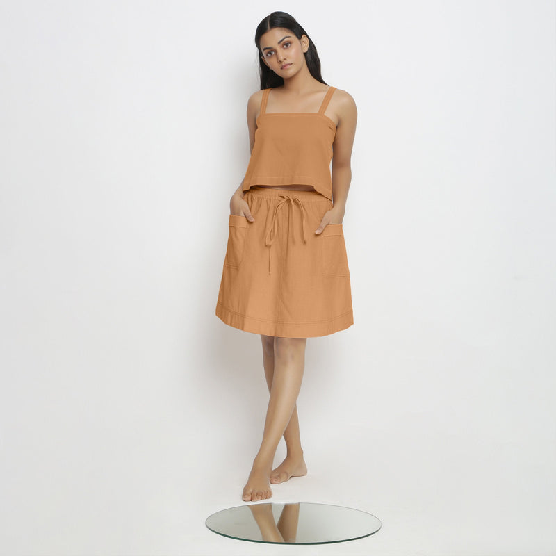 Front View of a Model wearing Vegetable-Dyed Rust 100% Cotton Mid-Rise Skirt