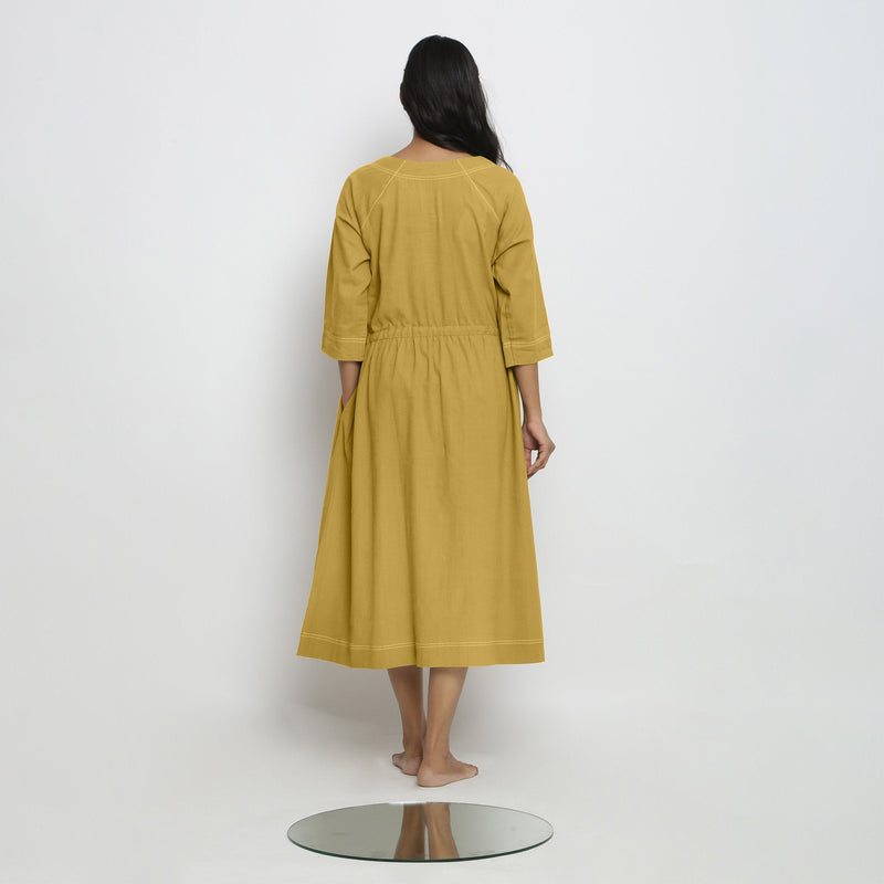 Back View of a Model wearing Vegetable-Dyed Yellow 100% Cotton Button-Down Dress