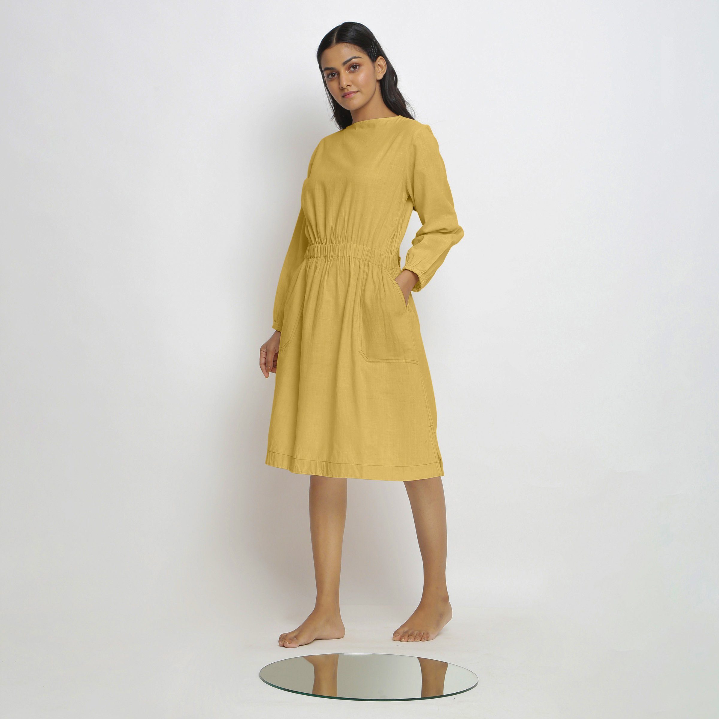 Left View of a Model wearing Vegetable-Dyed Yellow 100% Cotton Dress