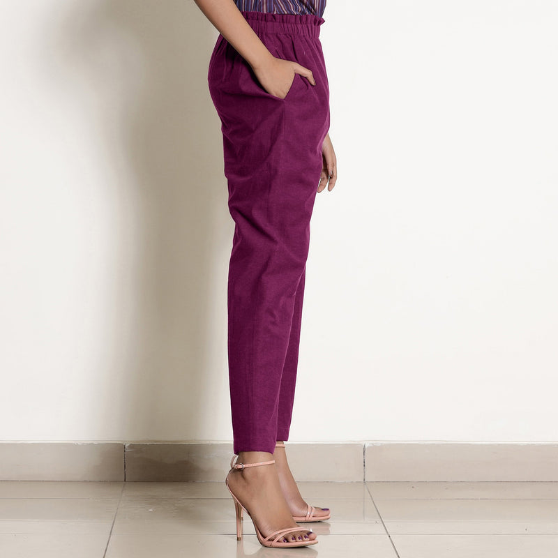 Left View of a Model wearing Warm Mulberry Frilled Waist Tapered Cotton Pant