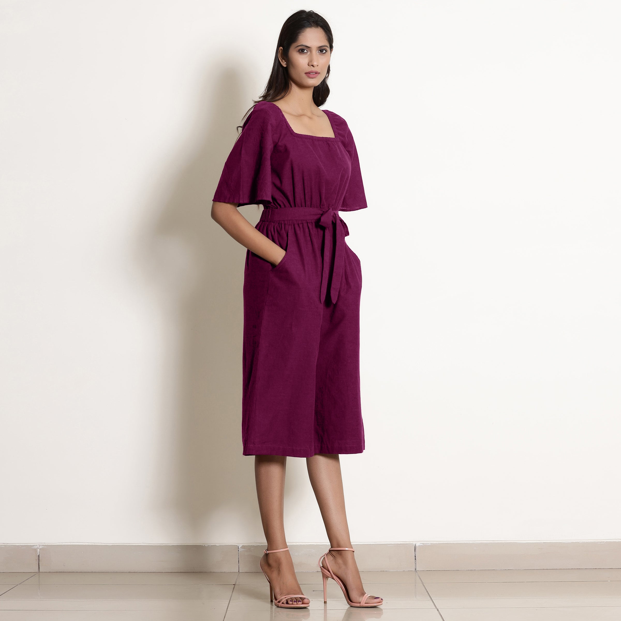 Right View of a Model wearing Warm Mulberry Loose Fit Cotton Jumpsuit
