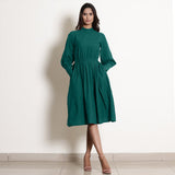 Front View of a Model wearing Warm Pine Green Fit and Flare Dress