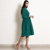 Right View of a Model wearing Warm Pine Green Fit and Flare Dress