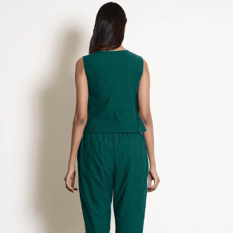 Back View of a Model wearing Warm Pine Green V-Neck Flared Top