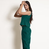Left View of a Model wearing Warm Pine Green V-Neck Flared Top