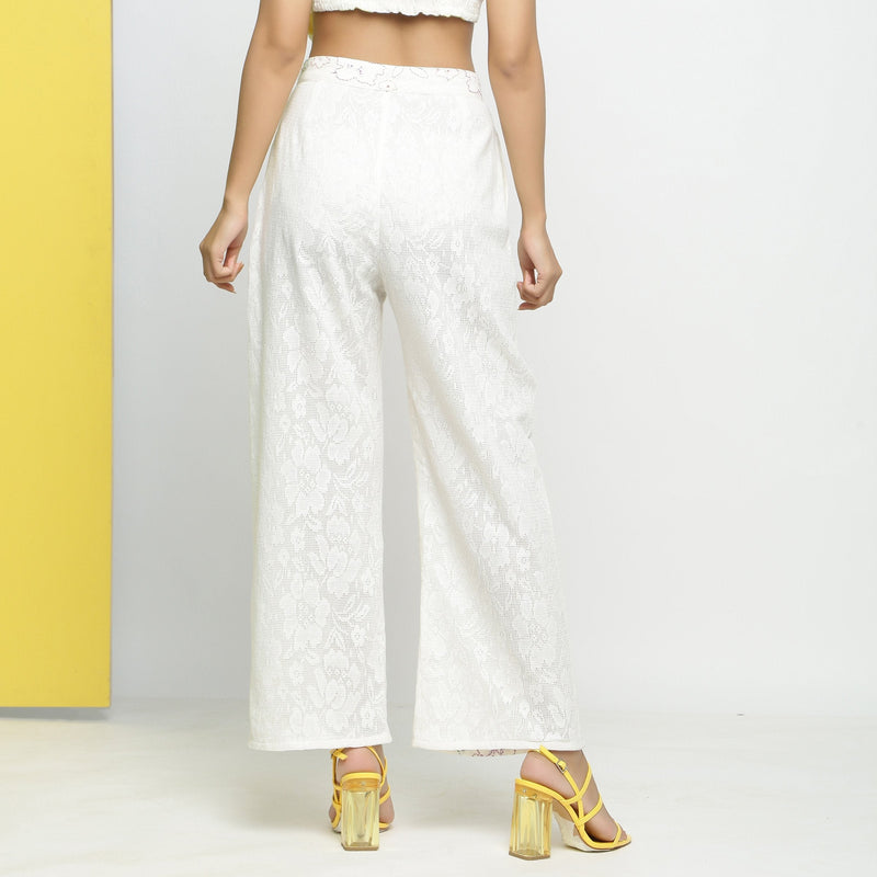 Back View of a Model wearing White Embroidered Cotton Lace Mid-Rise Paneled Pant