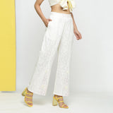 Right View of a Model wearing White Embroidered Cotton Lace Mid-Rise Paneled Pant