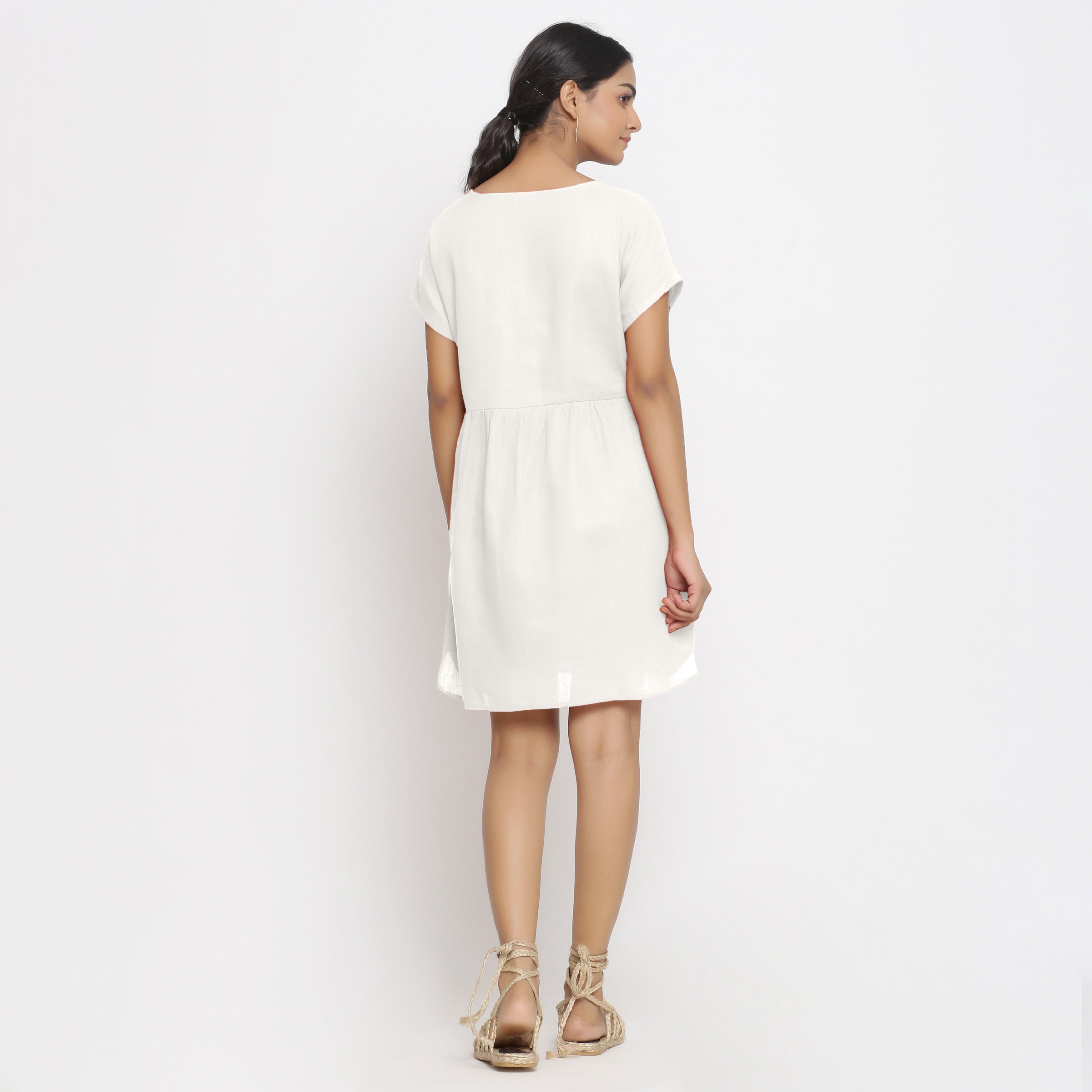 Back View of a Model wearing White Cotton Solid Wrap Dress