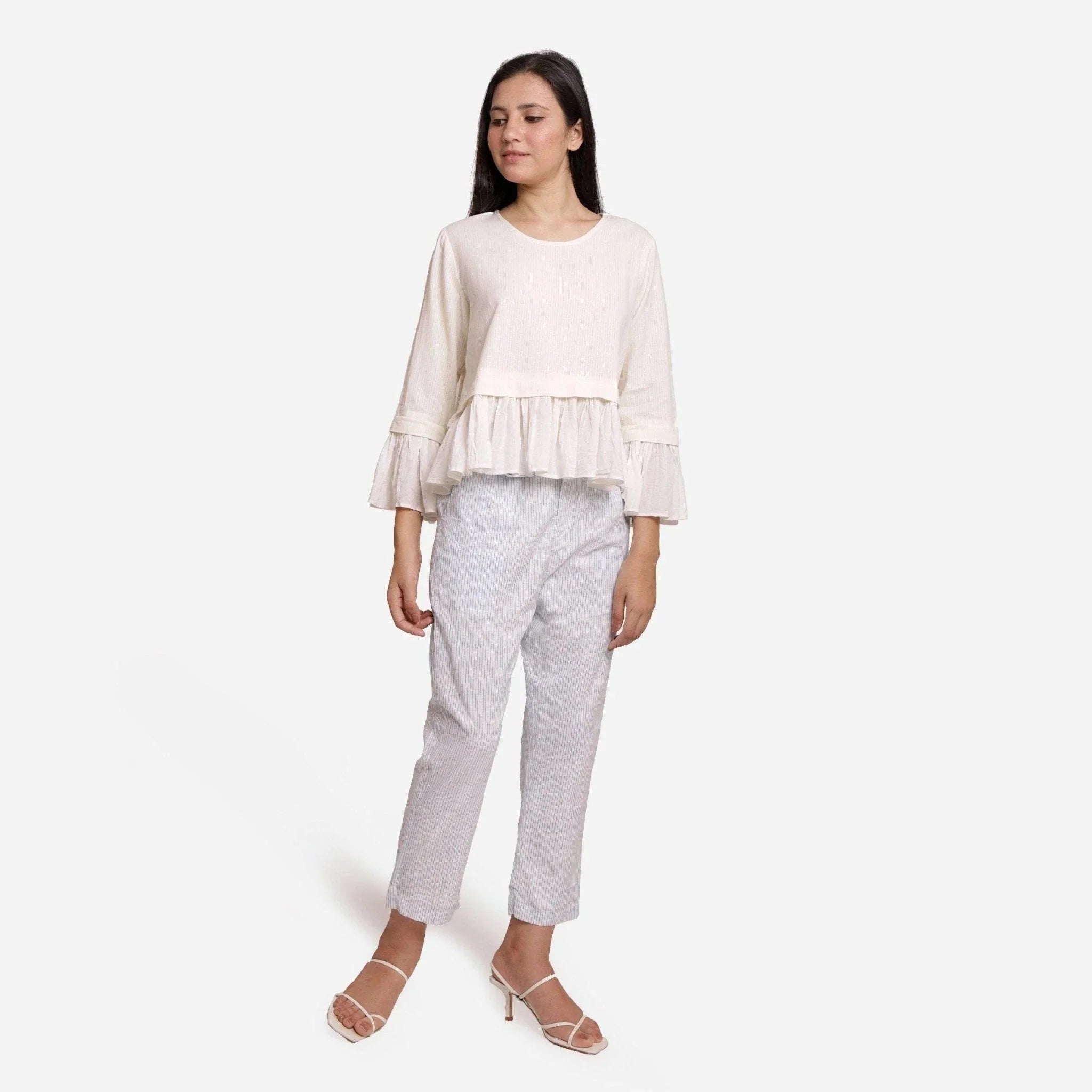 Front View of a Model wearing White Frilled Cotton Peplum Top