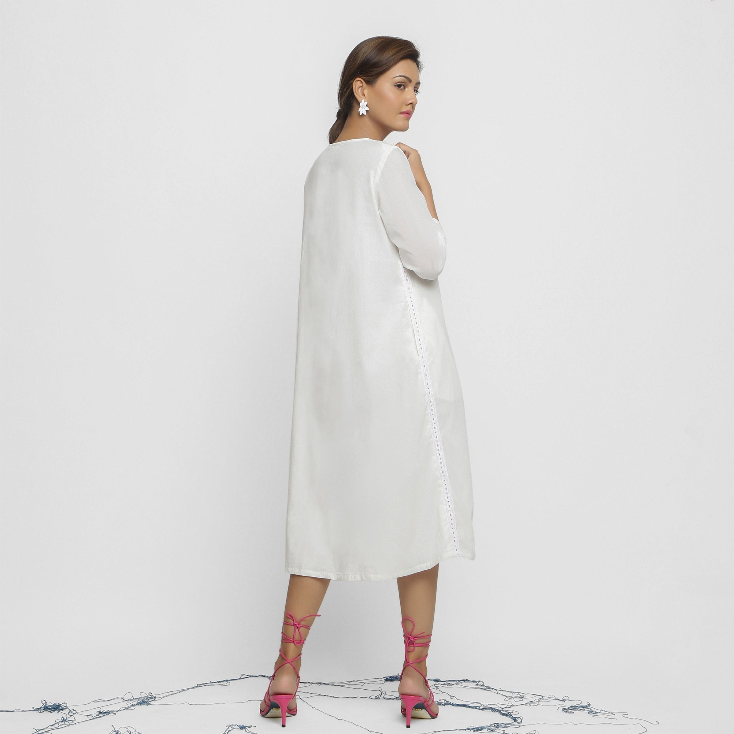 Back View of a Model wearing White Organic Cotton Hand Beaded Button-Down Midi Dress
