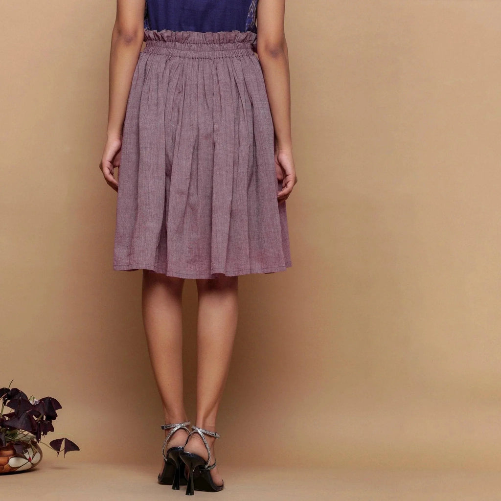 Back View of a Model wearing Wine Handspun Cotton Muslin Mid-Rise Paperbag Skirt