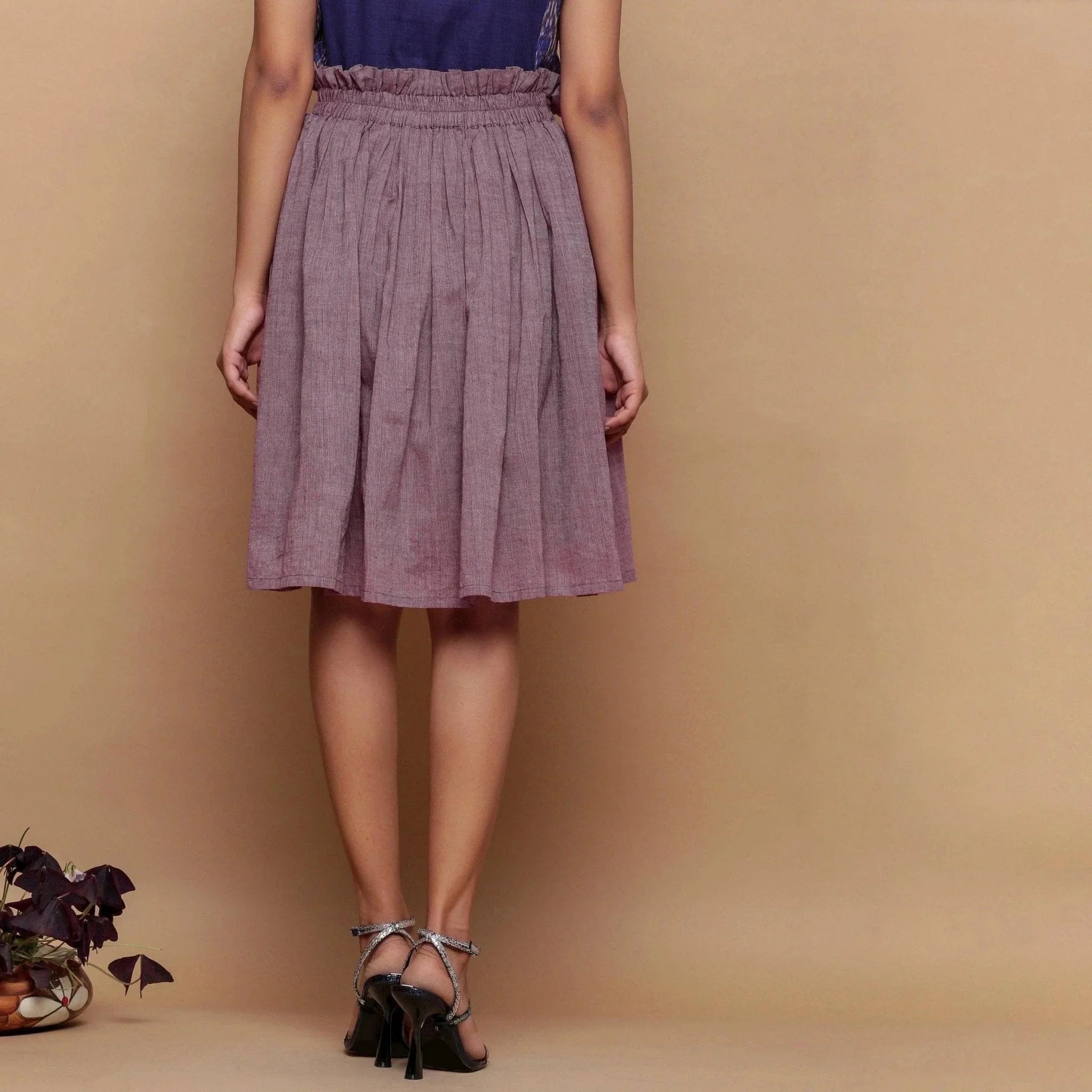 Back View of a Model wearing Wine Handspun Cotton Muslin Mid-Rise Paperbag Skirt