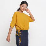 Right View of a Model wearing Solid Yellow Cotton Flax Blouson Top