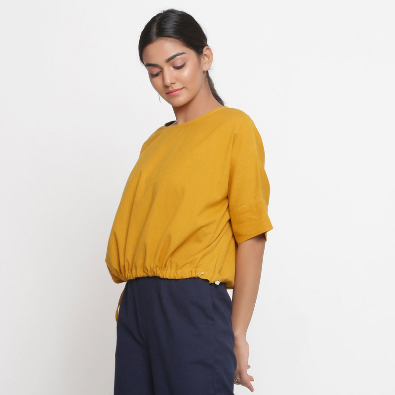 Left View of a Model wearing Solid Yellow Cotton Flax Blouson Top