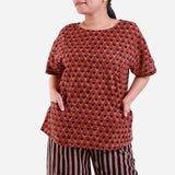 Front Detail of a Model wearing Brick Red Floral Block Print Straight Top