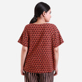 Back View of a Model wearing Brick Red Floral Block Print Straight Top