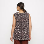 Back View of a Model wearing Black Floral Sleeveless Top