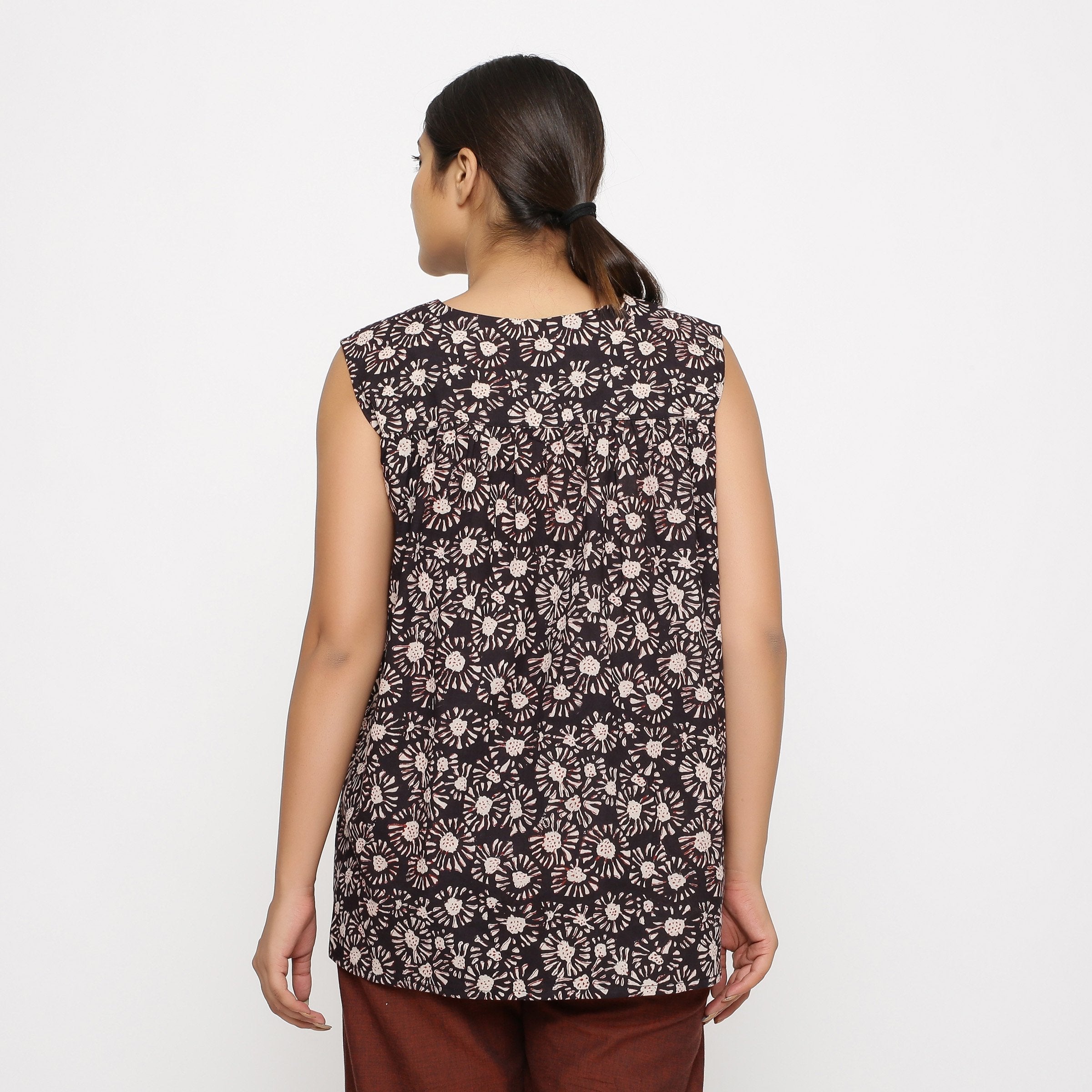 Back View of a Model wearing Black Floral Sleeveless Top
