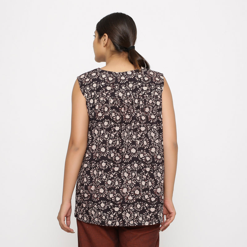 Back View of a Model wearing Black Floral Sleeveless Top