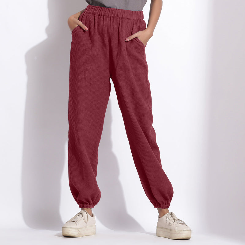 Front View of a Model wearing Comfy Barn Red Cotton Waffle Jogger Pants