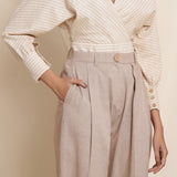Front Detail of a Model Wearing Dusk Brown Box Pleated Pegged Pant