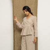 Left View of a Model wearing Beige Handspun Full Sleeve V-Neck Wrap Top