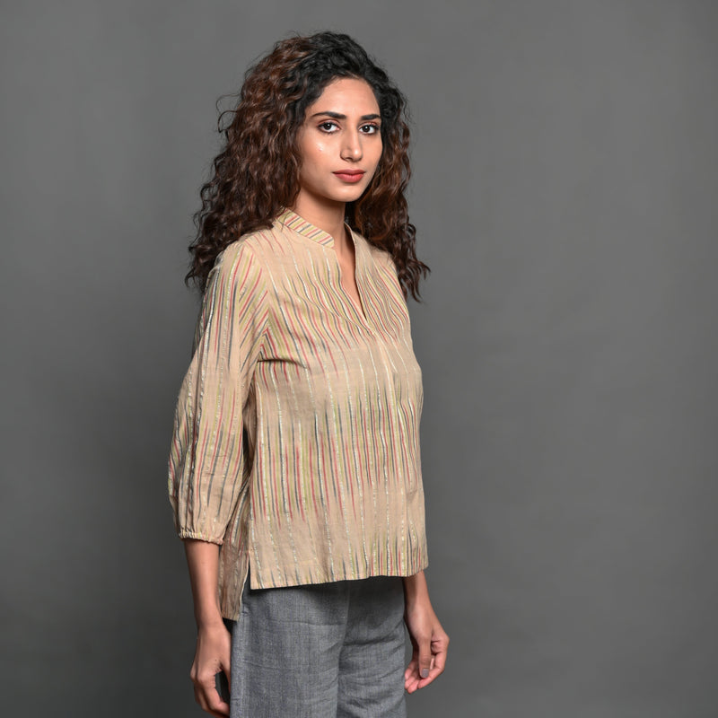 Right View of a Model wearing Beige Striped Handwoven Cotton Pleated Shirt