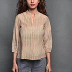 Front Detail of a Model wearing Beige Striped Handwoven Cotton Pleated Shirt