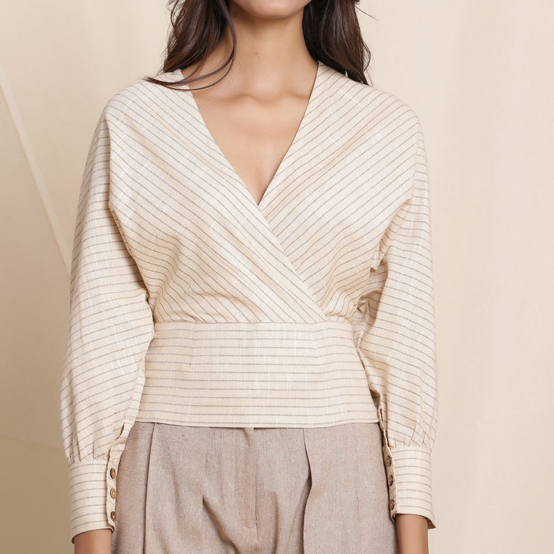 Front Detail of a Model wearing Beige Striped Surplice Blouson Top