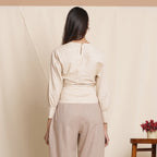 Back View of a Model wearing Beige Striped Surplice Blouson Top