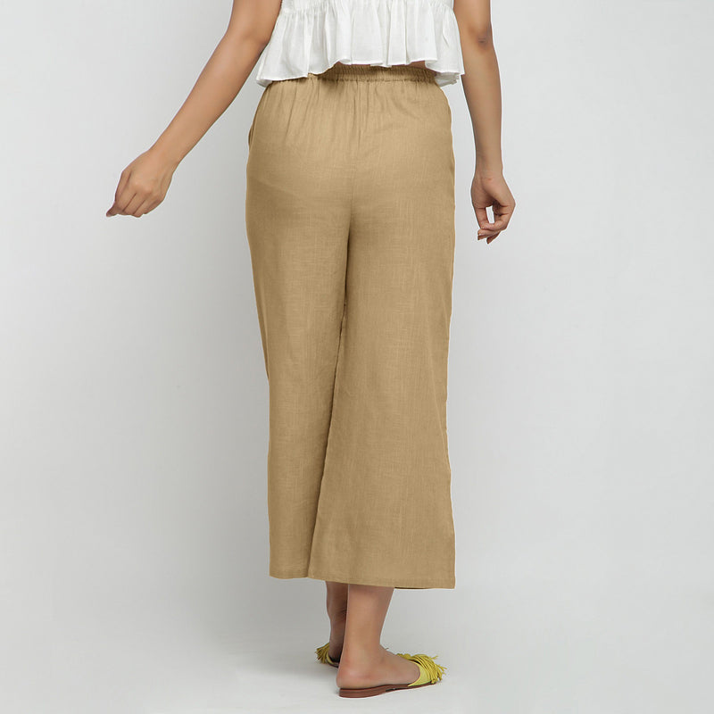 Back View of a Model wearing Beige Wide Legged Straight Pant