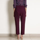 Back View of a Model wearing Warm Berry Wine Frilled Waist Tapered Pant