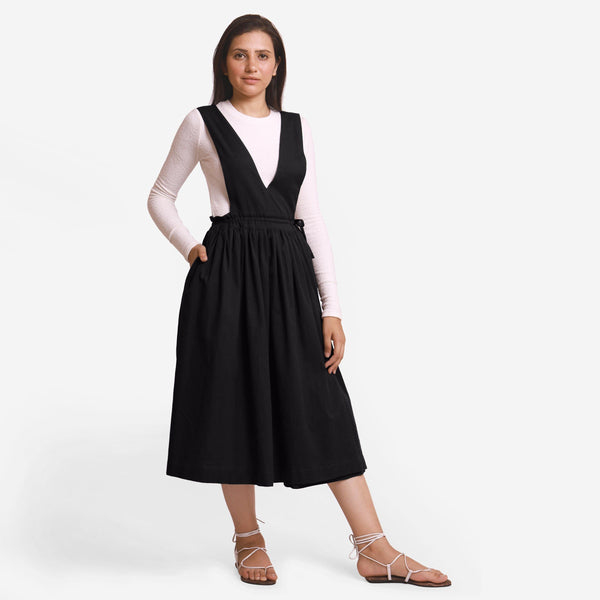 Front View of a Model wearing Black Deep Neck Pinafore Midi Wrap Dress