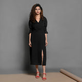 Front View of a Model wearing Black Handspun Cotton Pleated Midi Slit Dress