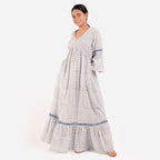 Left View of a Model wearing Blue Block Printed Bell Sleeves Tier Dress