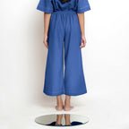 Back View of a Model wearing Powder Blue Vegetable Dyed Wide Legged Pant