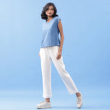 Left View of a Model wearing Blue Essential Top and Off-White Pant Set