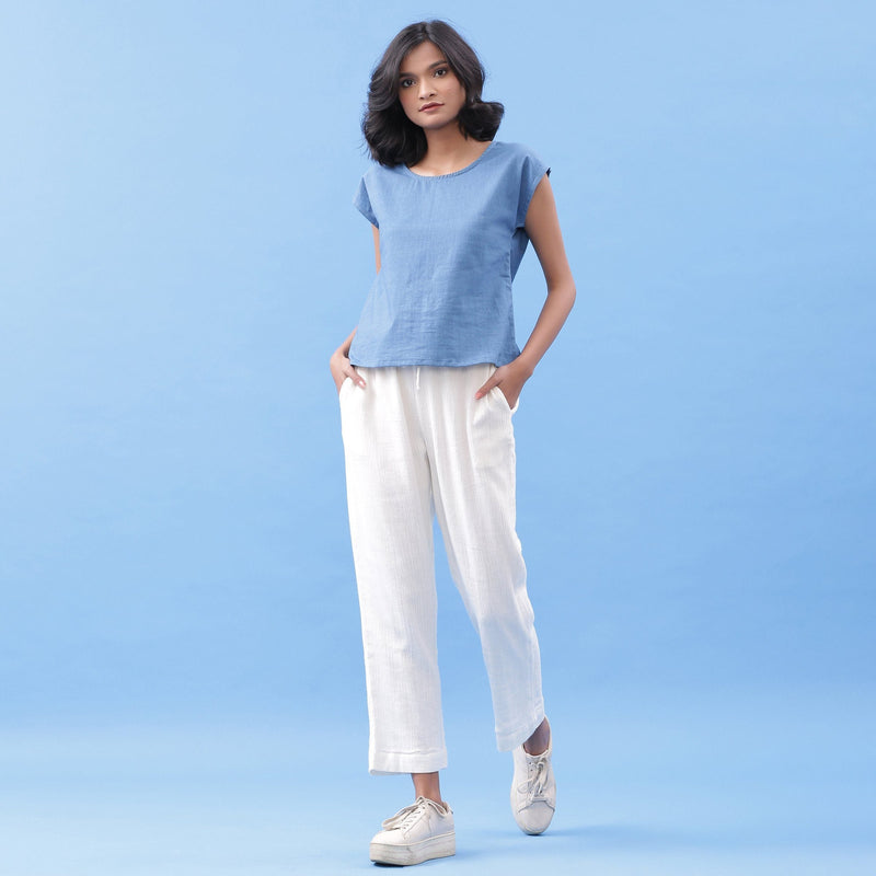 Front View of a Model wearing Blue Essential Top and Off-White Pant Set