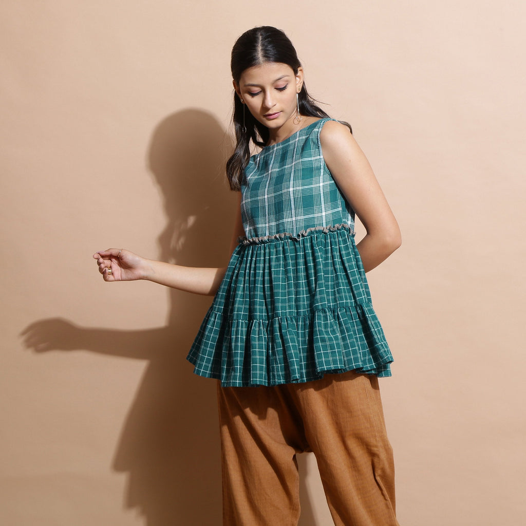 Left View of a Model wearing Bottle Green Handspun Boat Neck Tier Top