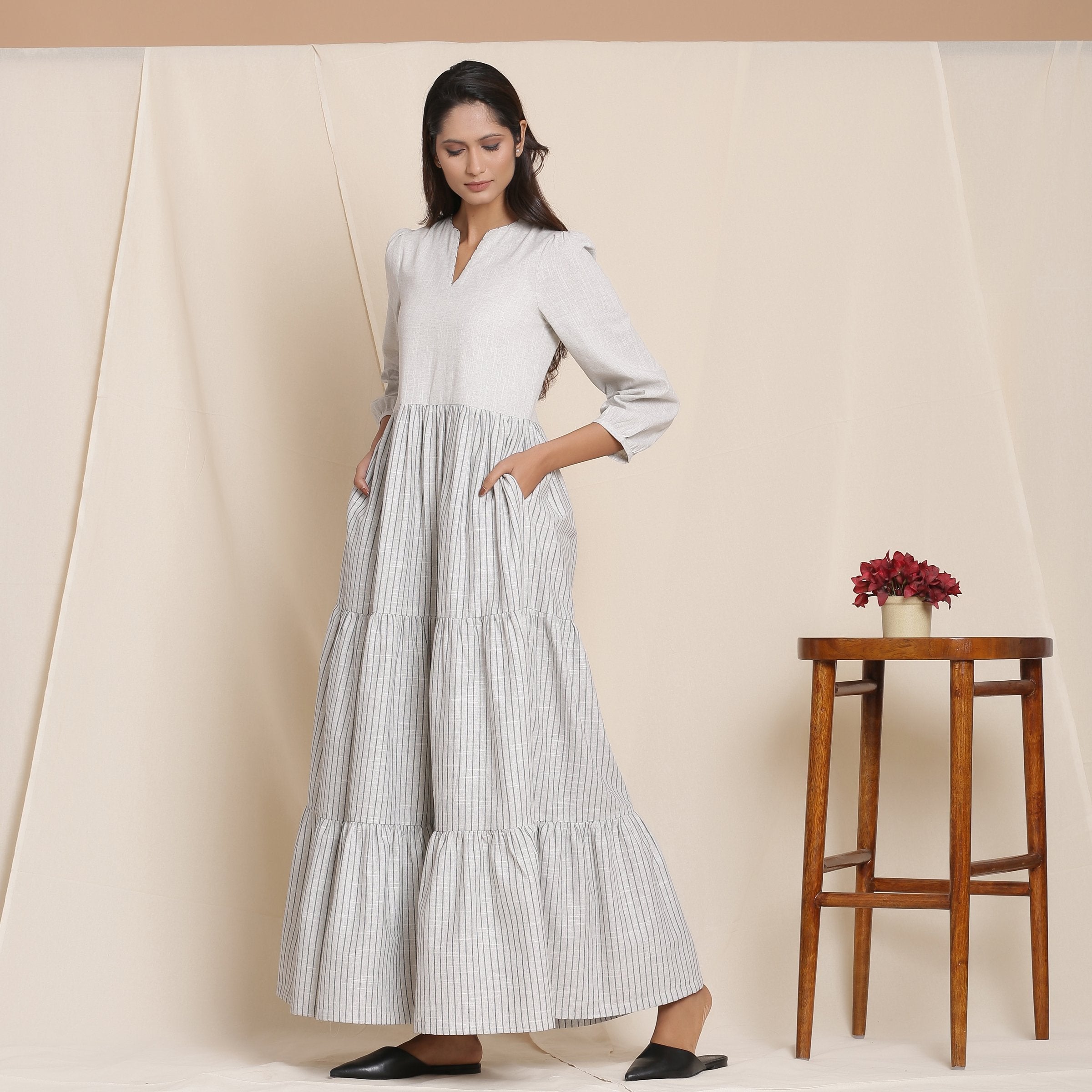 Left View of a Model wearing Breezy Cloudy Grey Striped Tier Dress