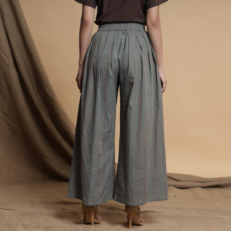 Back View of a Model wearing Grey Striped Wide Legged Pleated Pant