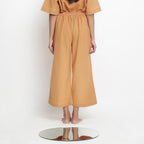 Back View of a Model Wearing Vegetable Dyed Rustic Wide Legged Pant