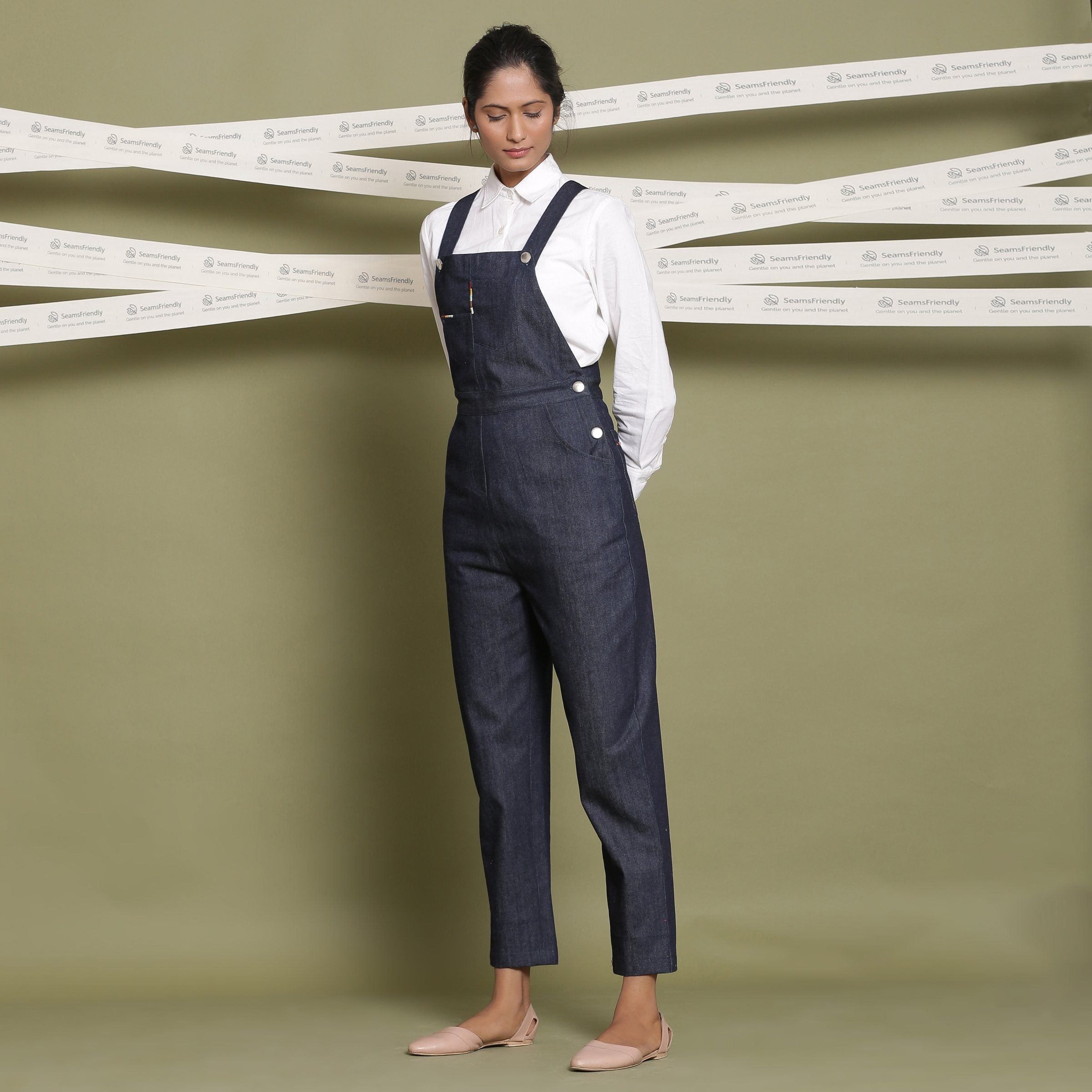 Left View of a Model wearing Classic White Shirt and Indigo Dungaree Set