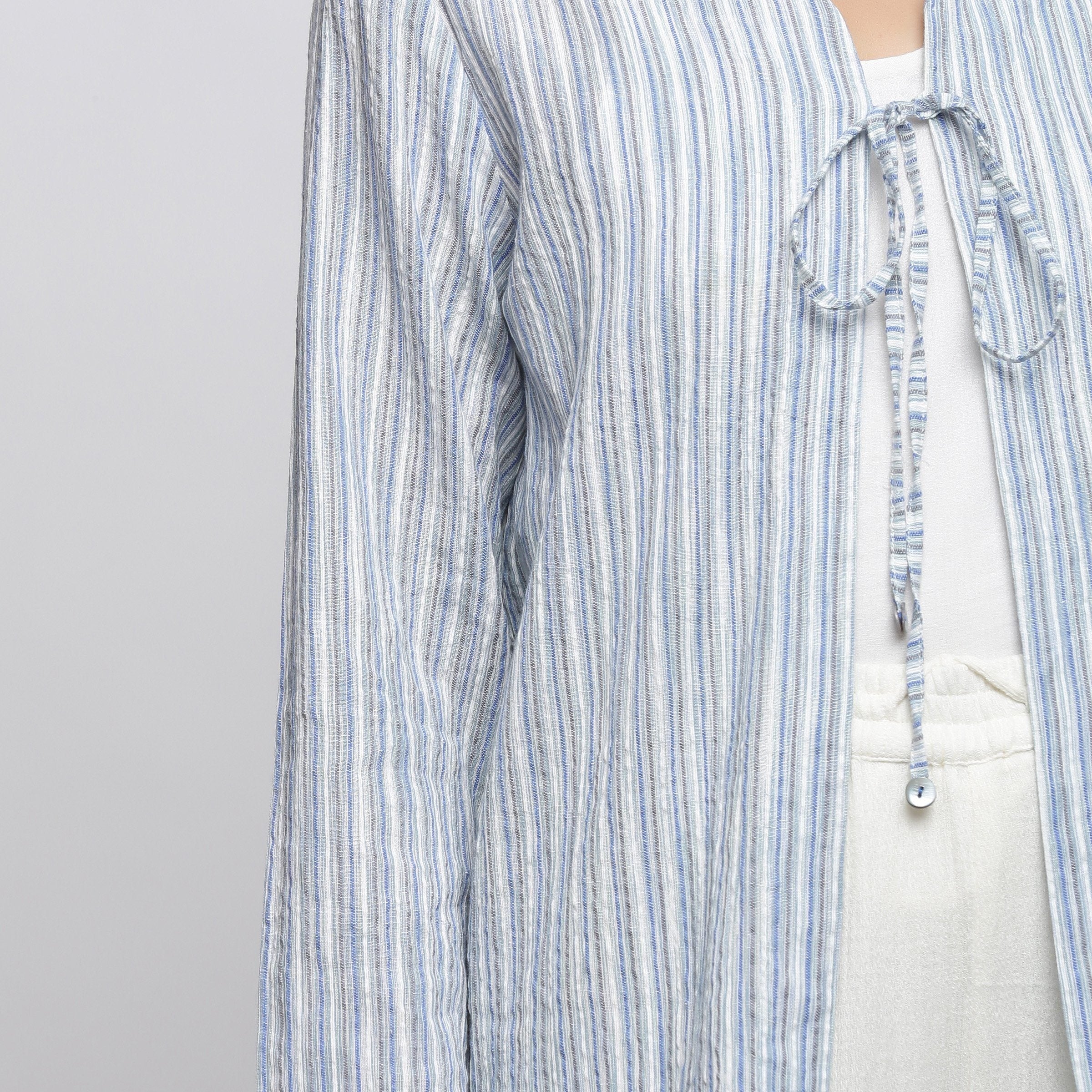 Front Detail of a Model wearing Blue And White Striped V-Neck Shrug