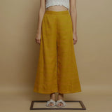 Front View of a Model wearing Mustard Paneled Striped Handwoven Pant