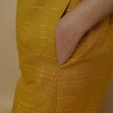 Close View of a Model wearing Mustard Paneled Striped Handwoven Pant