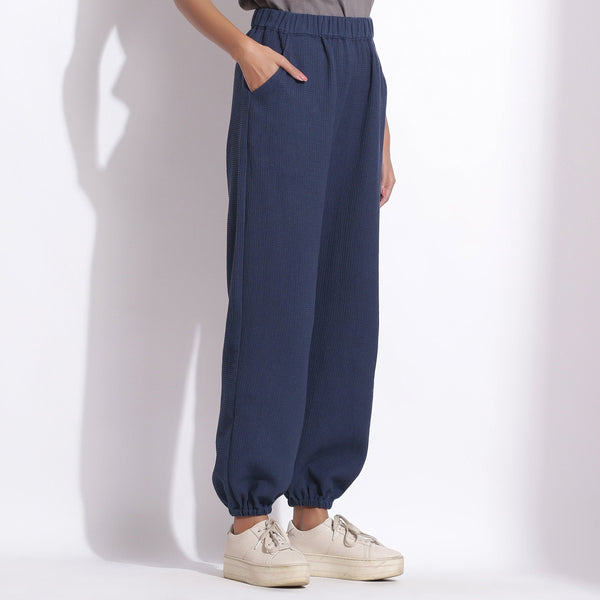 Left View of a Model wearing Comfy Navy Blue Cotton Waffle Jogger Pant